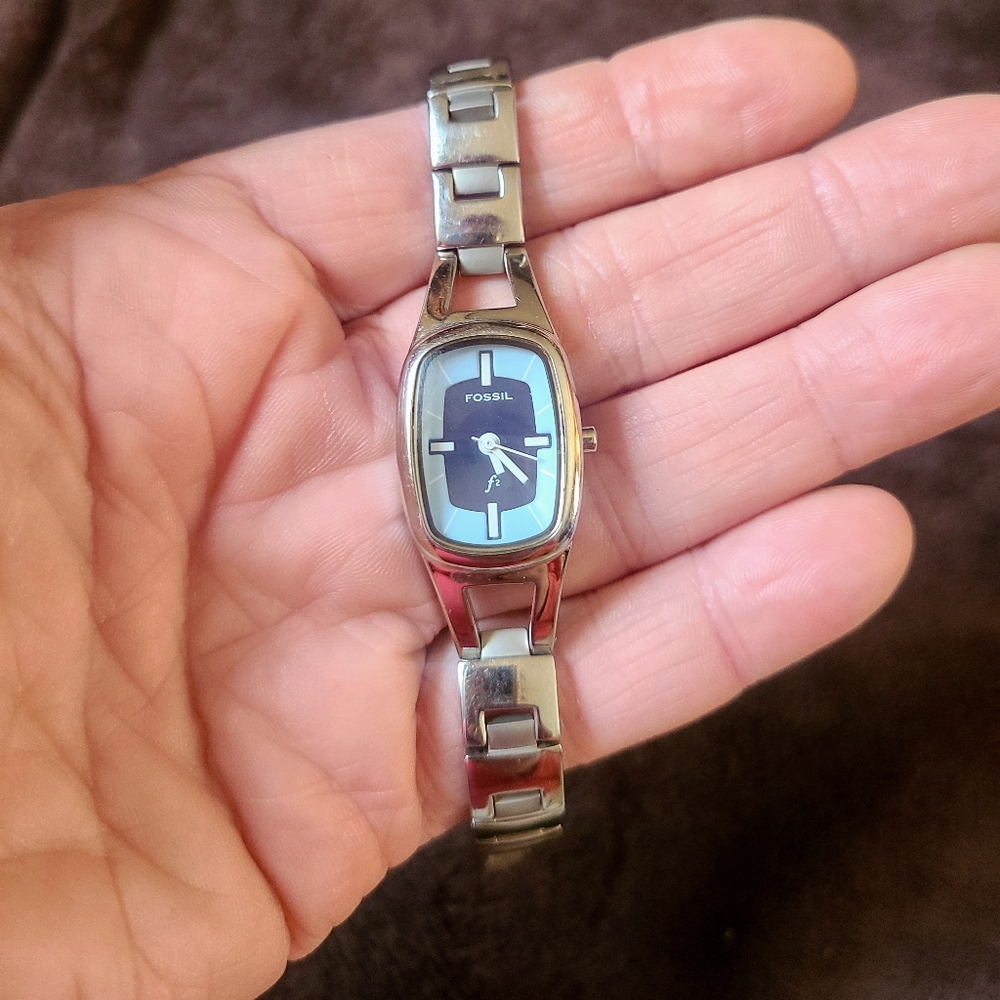 Fossil watch with light blue and silver face. Needs battery.